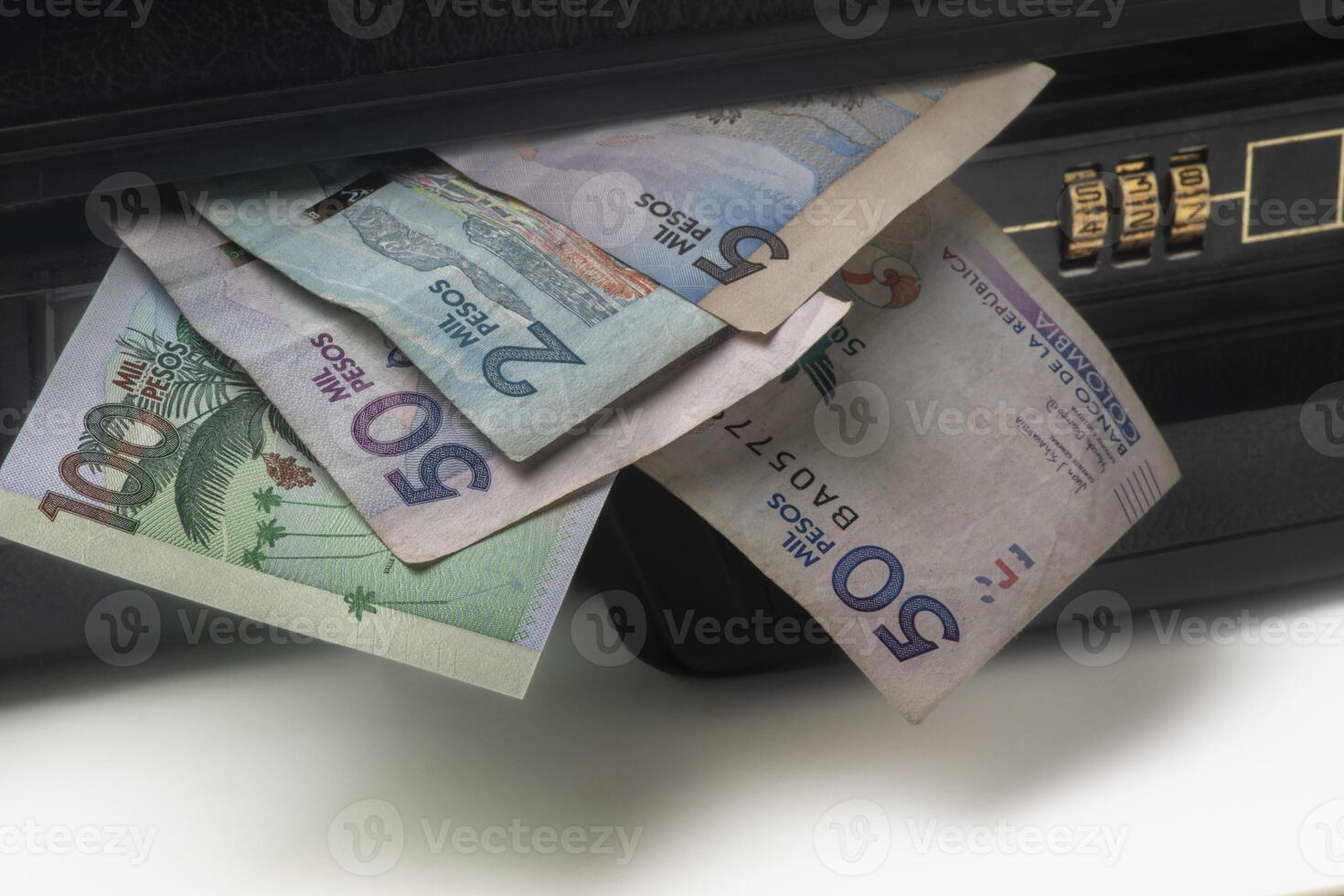 Business briefcase full of money with Colombian pesos photo