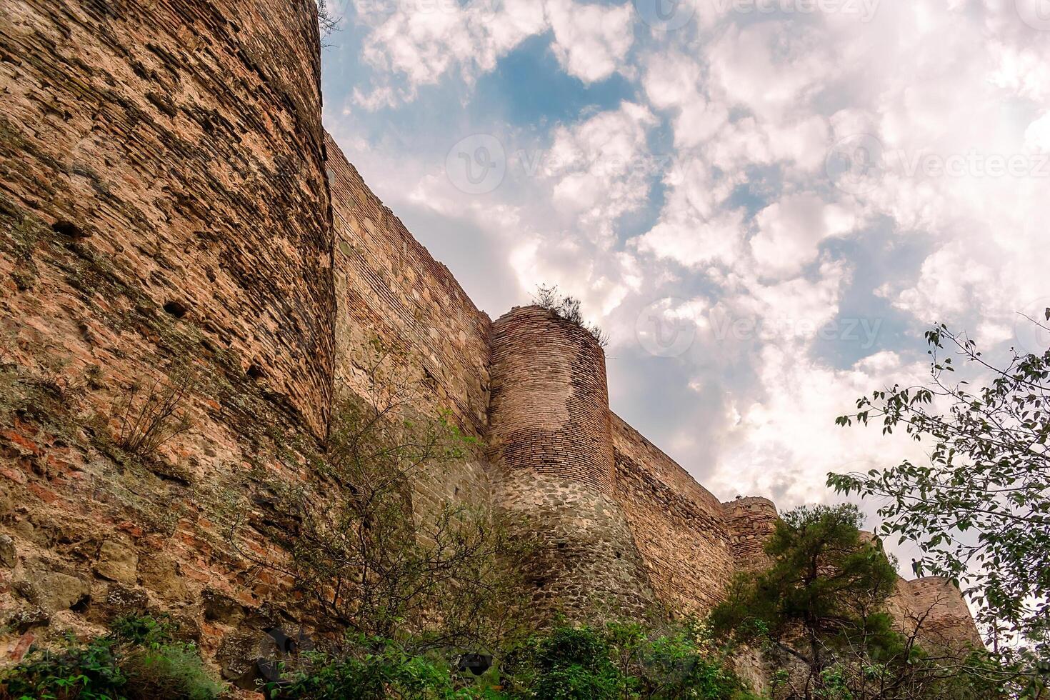 View of the fortress in Tbilisi from the botanical garden. High walls in Tbilisi. photo