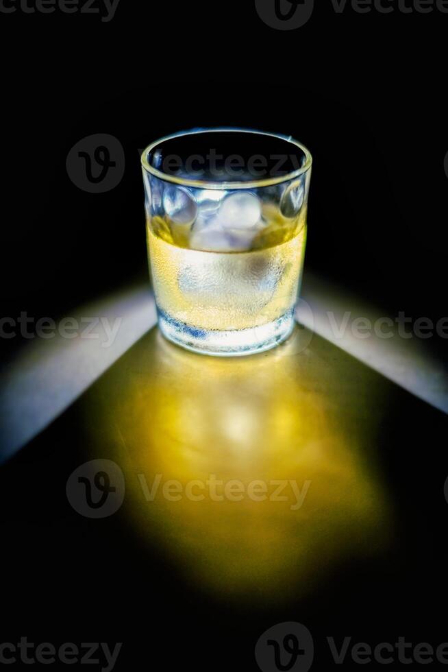 Glass of whiskey on the rocks photo