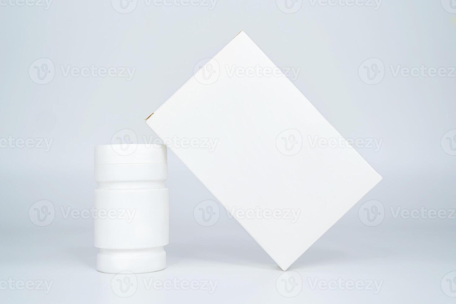 Medicine bottle and package separately on gray background photo