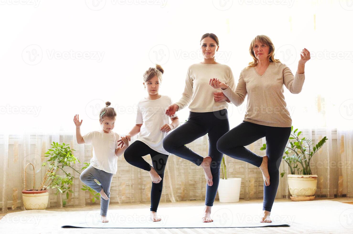 Multi generational family doing yoga together photo