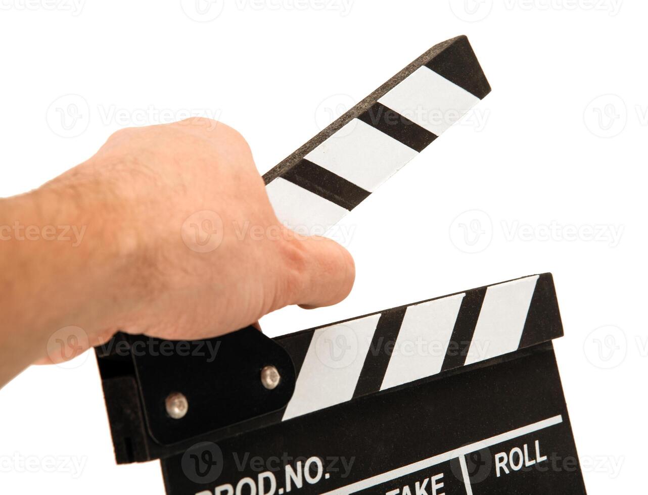 black movie clapper with white inscriptions in the hand on a white table photo