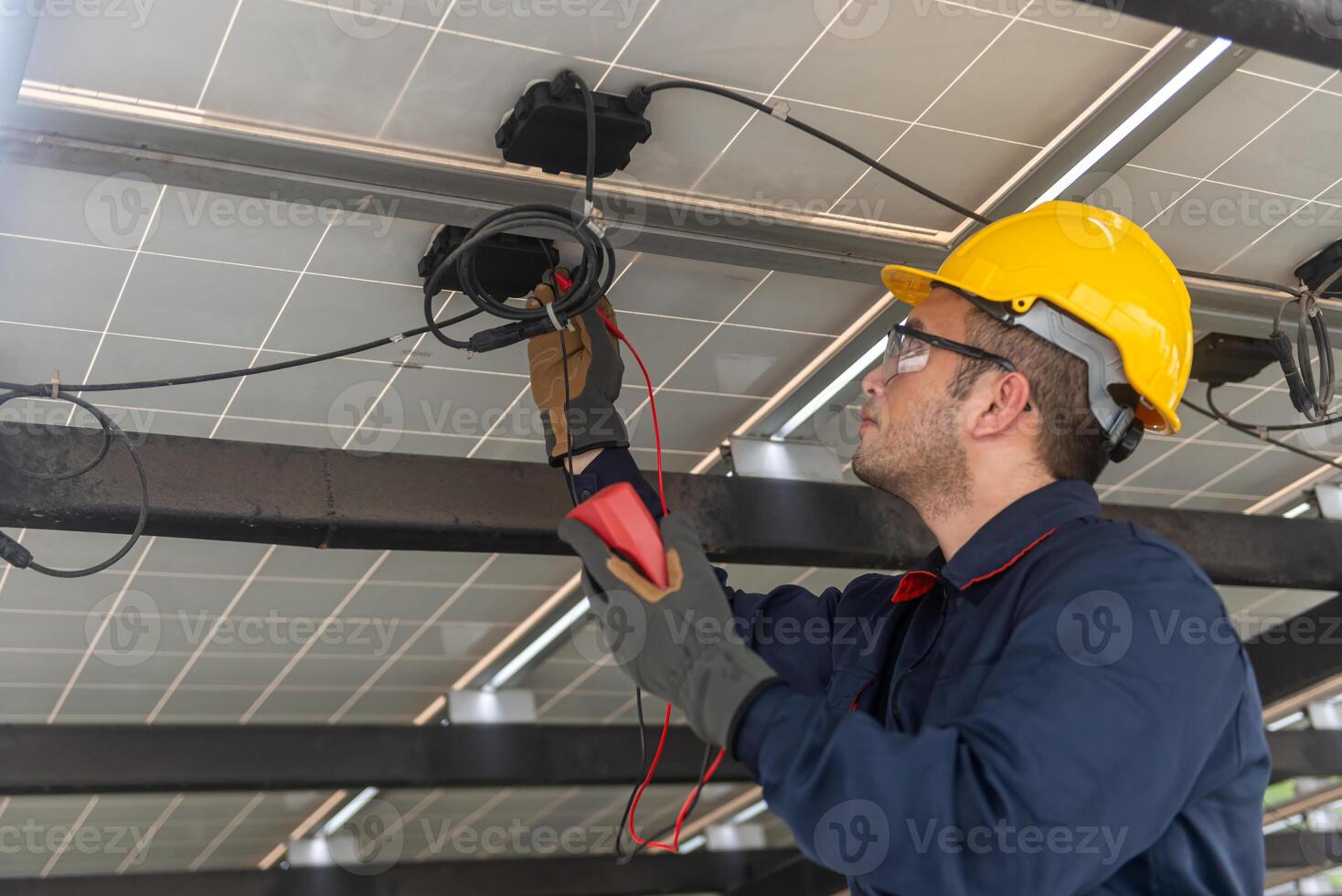 Engineer technical service checking solar panel with electricity meter for check the voltage, checking the solar system work properly photo