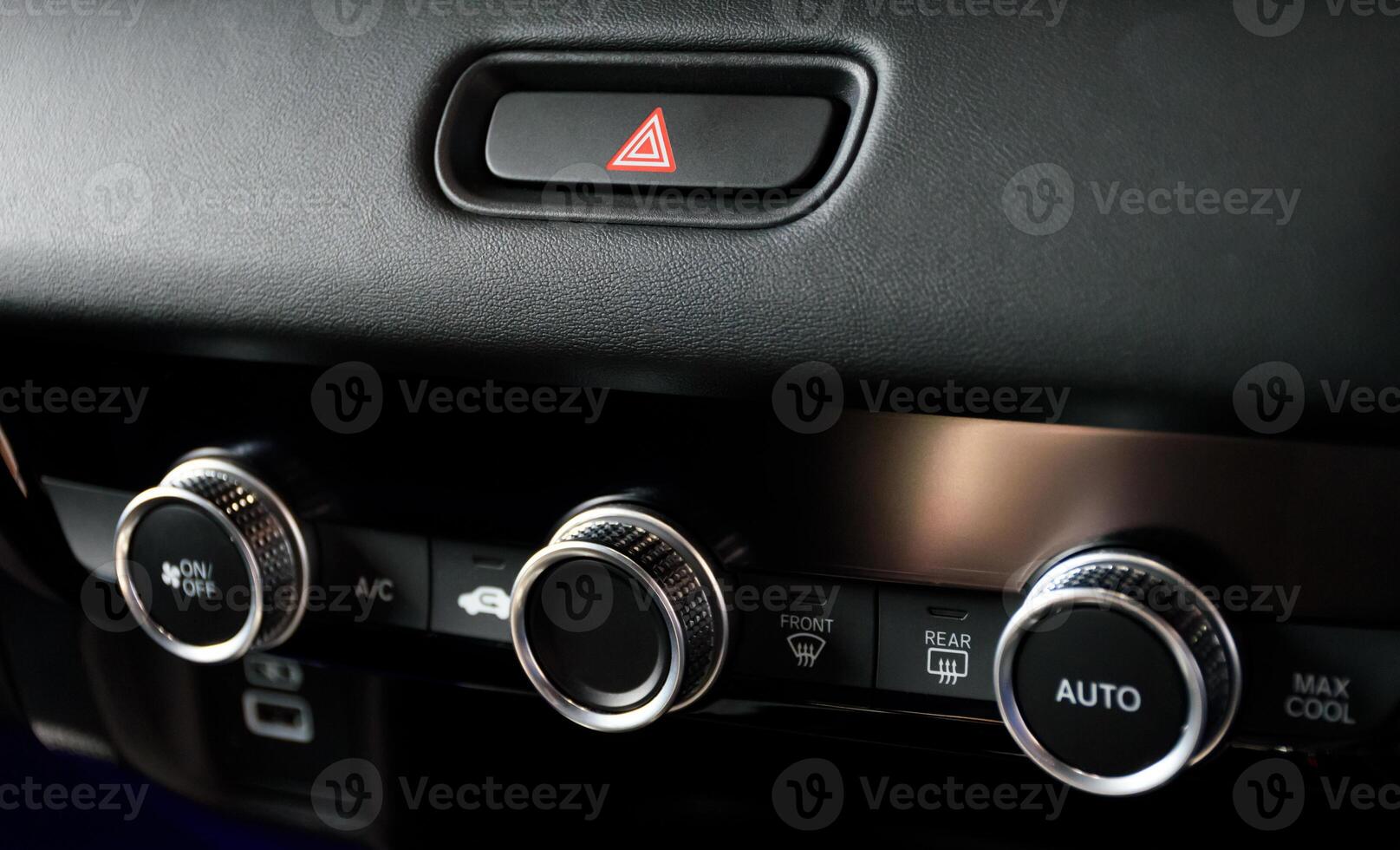 Button automatically adjust the air conditioning temperature and emergency light button in a modern car luxury interior 2024. Function control panel buttons in modern car. photo