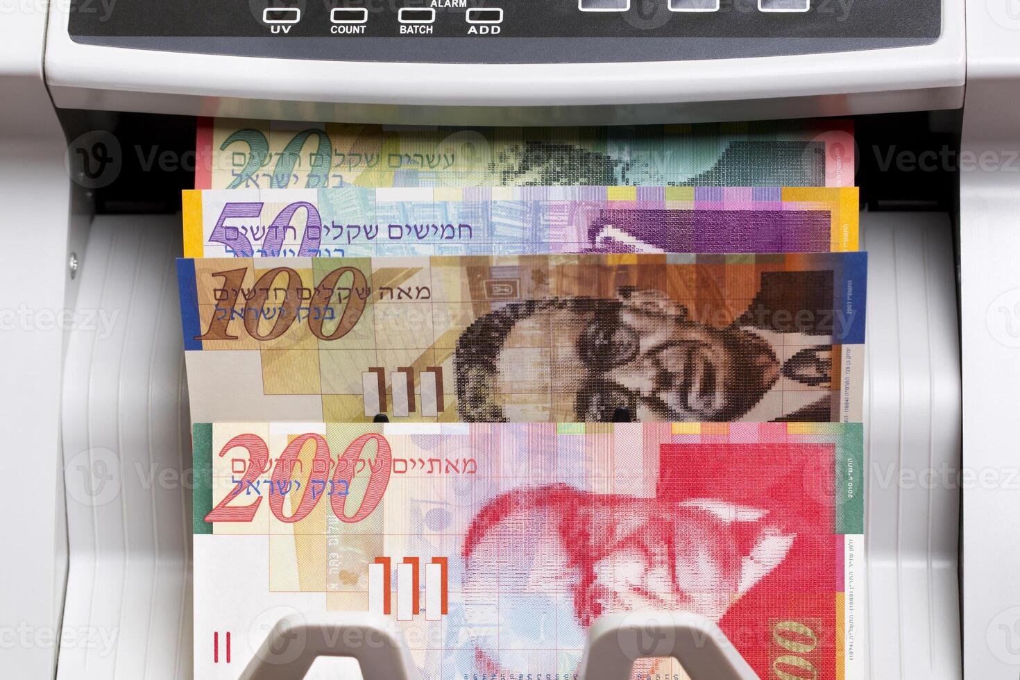 Israeli new shekel in the counting machine photo
