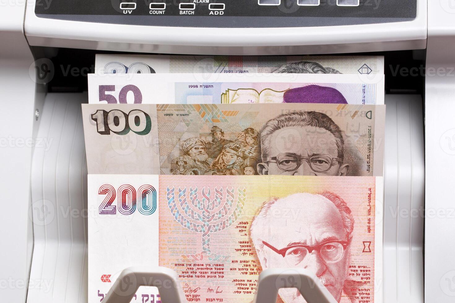 Israeli new shekel in the counting machine photo