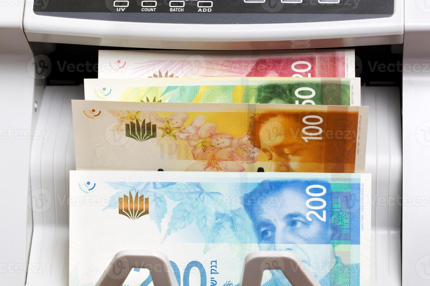 Israeli new shekel in the counting machine photo
