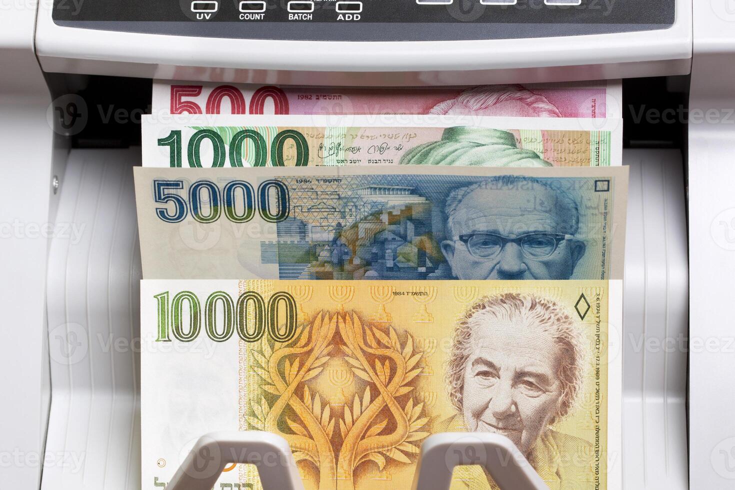 Israeli new shekel in the counting machine photo