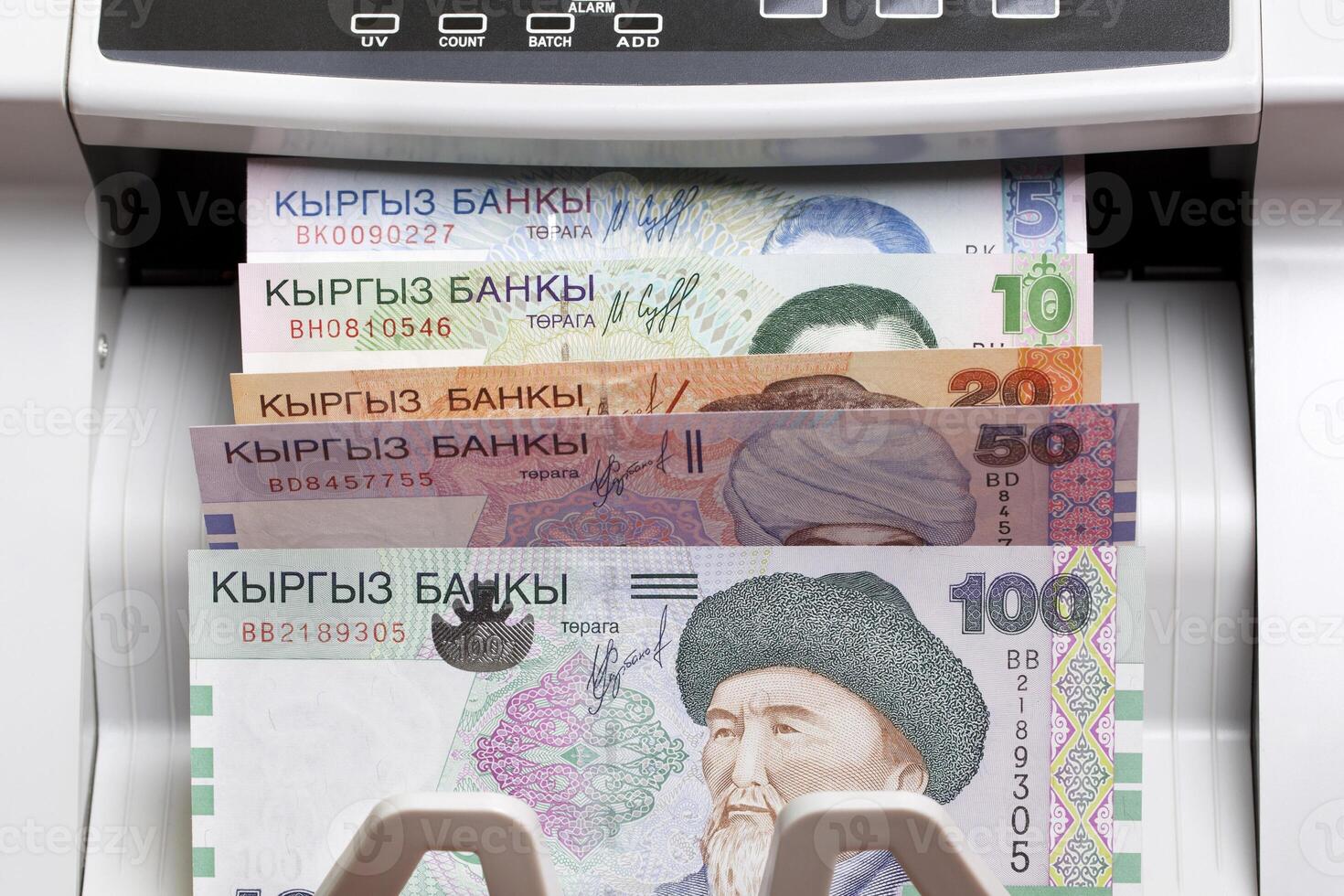 Old Kyrgyz som in the counting machine photo
