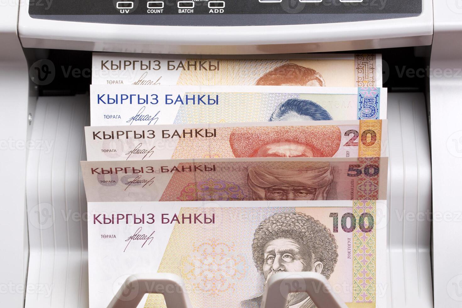 Old Kyrgyz som in the counting machine photo