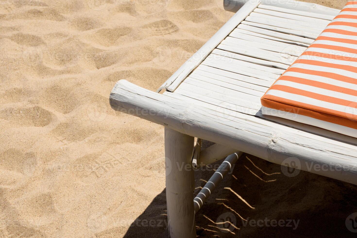 Beach chair with Sleeping pad on the white sand beach minimalism with copy space. Deckchair on the beach. Vacation, Beach, Travel, Relaxation concept. photo