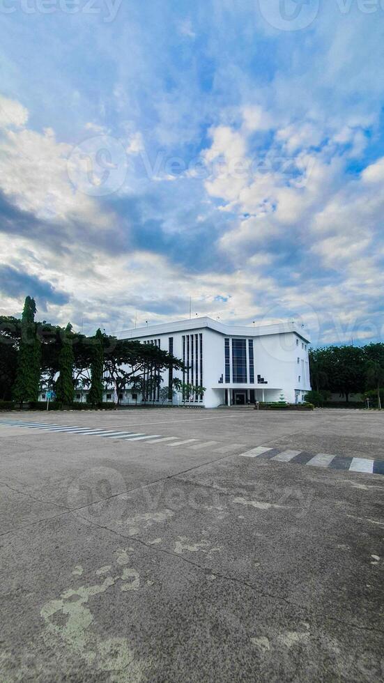 Modern minimalist white house inspiration. White building under the beautiful blue sky and cloud. photo