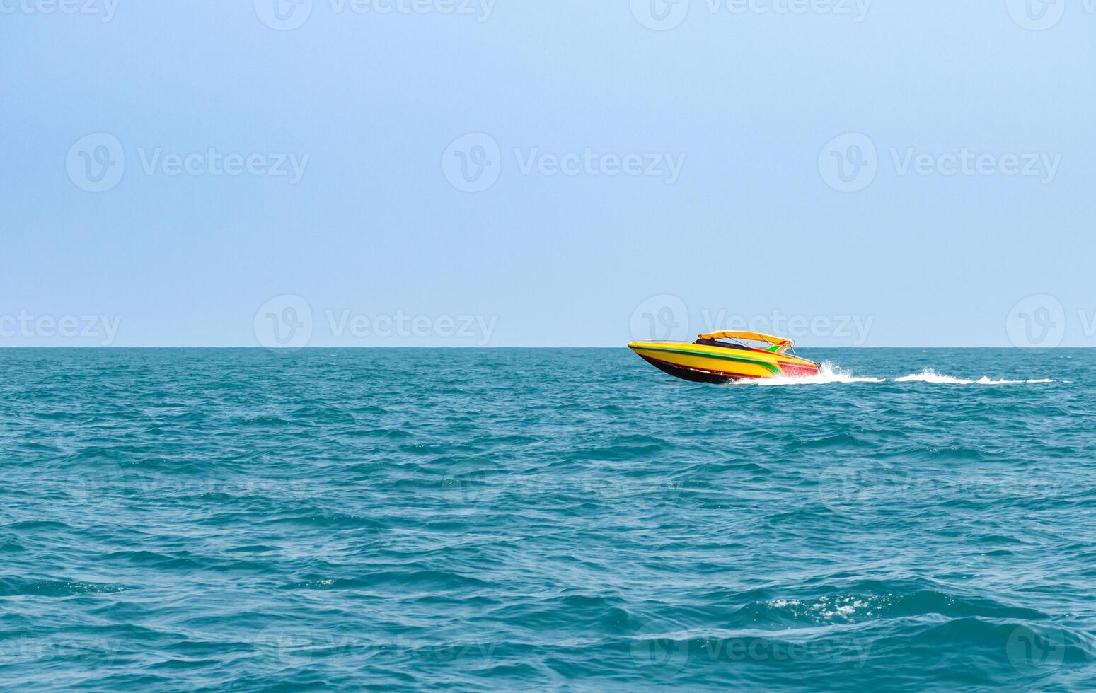 Speedboat sailing on the blue tropical sea on the background clear blue sky morning day at Koh Larn island. Speed boat running on the bay, Panorama ocean, Pattaya, Thailand, Vacation. photo