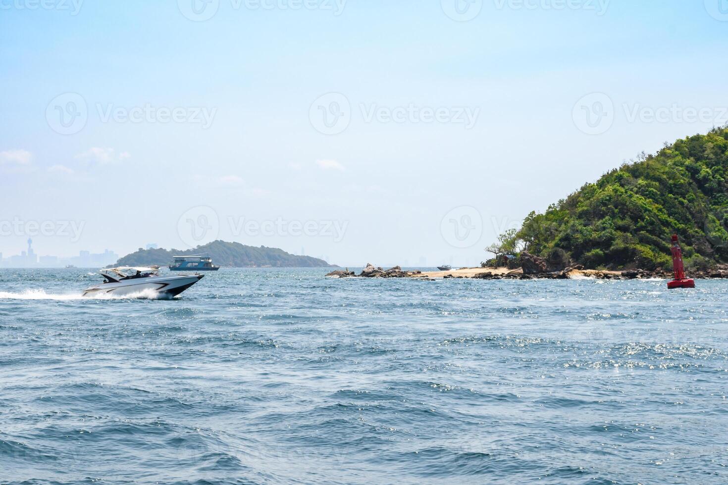 Landscape of island and tropical beach morning day at Koh Larn island on blue sea and blue clear sky background. Pattaya, Thailand. Wave, Speed boat, Ferry ship, Seascape, Vacation, Summer, Holiday. photo