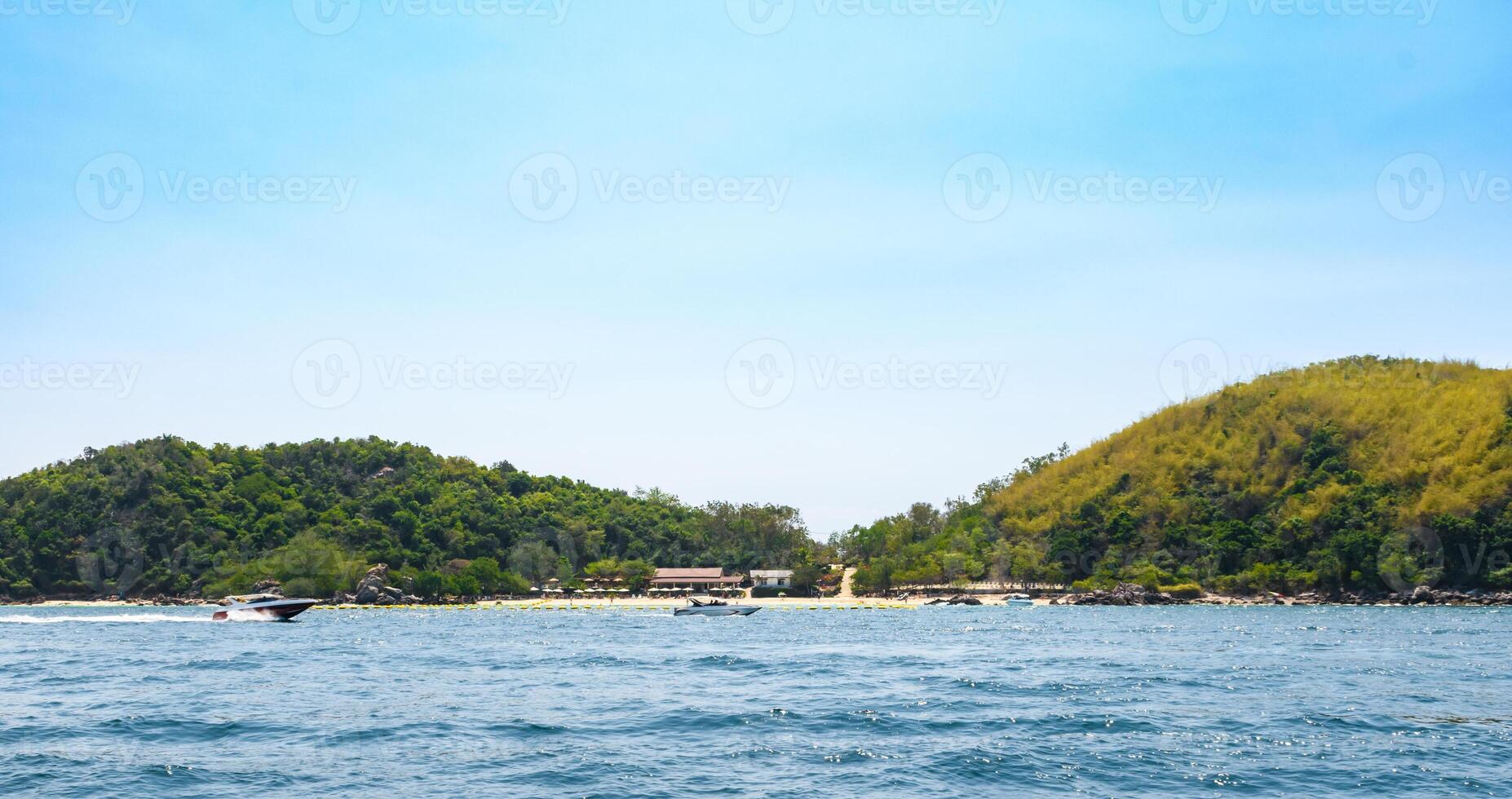 Landscape of tropical beach and island morning day at Koh Larn island on blue sea and blue clear sky background. Pattaya, Thailand. Wave, Speed boat, Ferry ship, Seascape, Vacation, Summer, Holiday. photo
