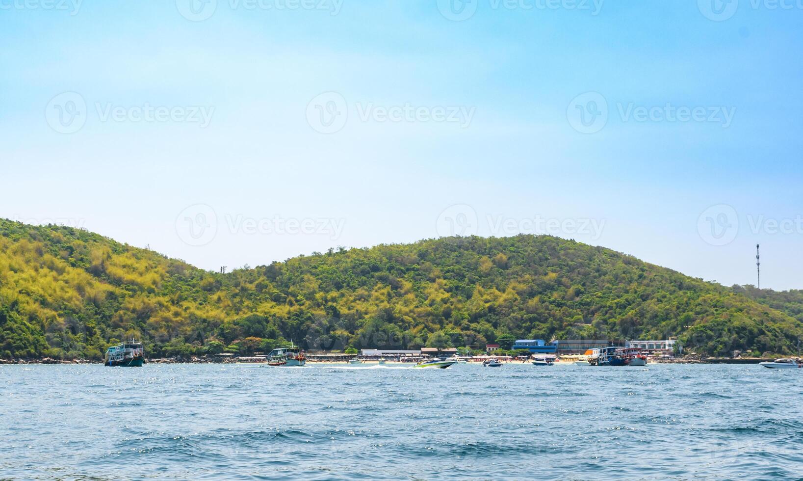 Boat sailing on the blue tropical sea on the background of island and tropical beach morning day at Koh Larn island. Ferry ship running on the bay, Panorama ocean, Pattaya, Thailand, Vacation. photo