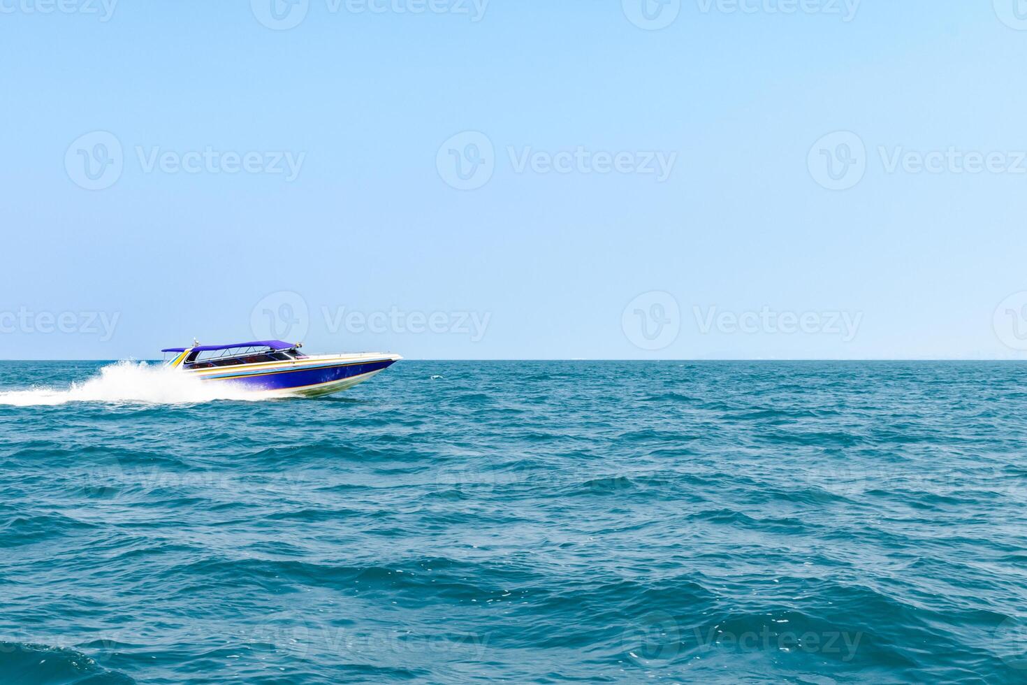 Speedboat sailing on the blue tropical sea on the background clear blue sky morning day at Koh Larn island. Speed boat running on the bay, Panorama ocean, Pattaya, Thailand, Vacation. photo