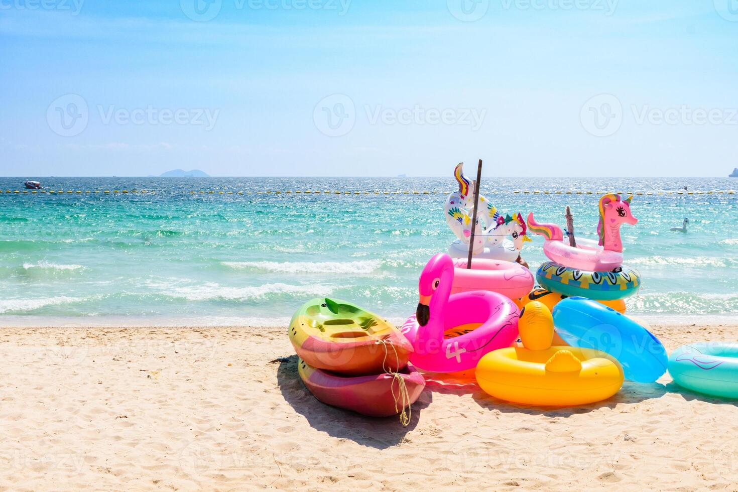 Colorful swim ring on the tropical beach, Fancy floating on the beach, Landscape of a Blue sea at Koh Larn island, Vacation, Summer, Holiday, Nature, Relax, No people, Pattaya, Thailand. photo