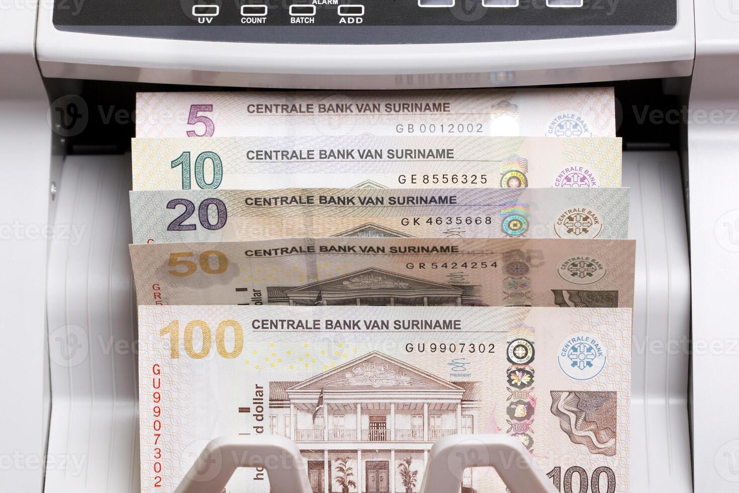 Surinamese dollar in the counting machine photo