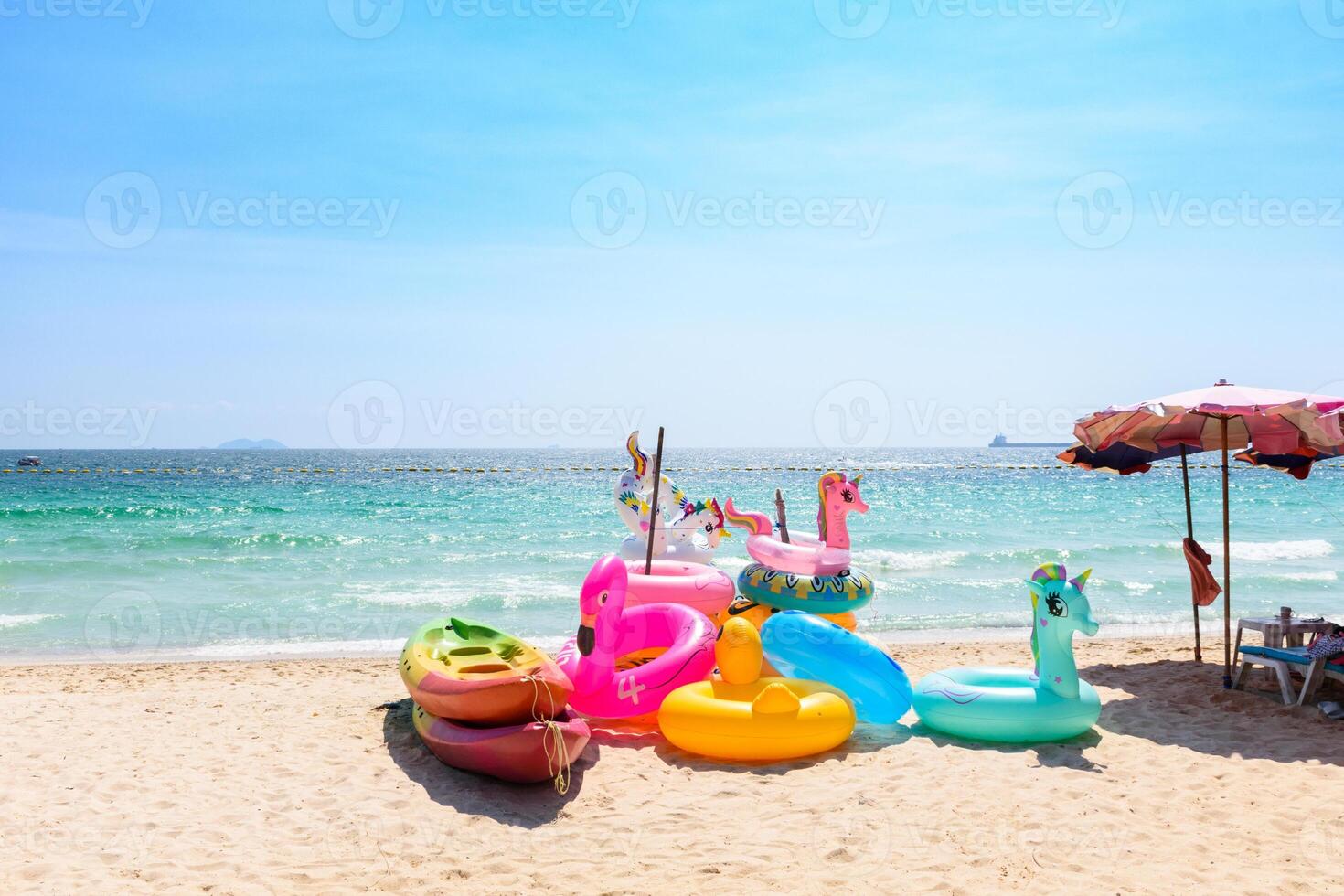 Colorful swim ring on the tropical beach, Fancy floating on the beach, Landscape of a Blue sea at Koh Larn island, Vacation, Summer, Holiday, Nature, Relax, No people, Pattaya, Thailand. photo
