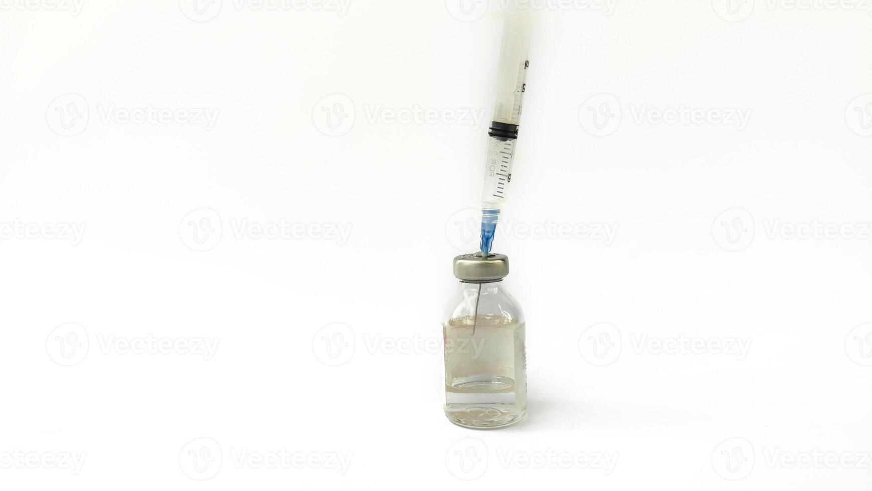 Vial of Drug or Vaccine and 3 ml Plastic Syringe with Needle Isolated on the White Background, blue tone color photo
