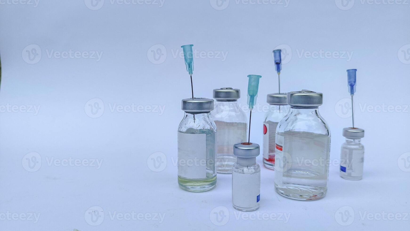 Vial of Drug or Vaccine and 3 ml Plastic Syringe with Needle Isolated on the White Background, blue tone color photo