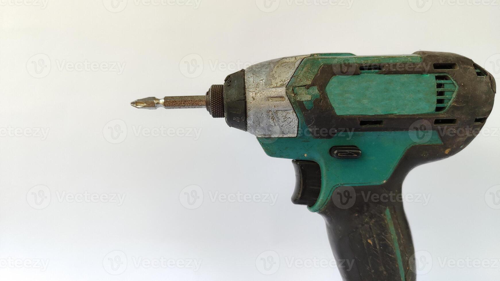 Cordless drill with drill bits, white background for copy space. photo