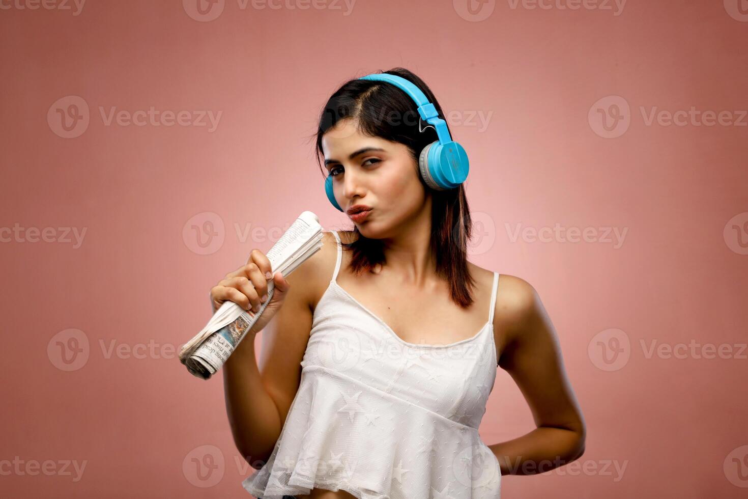 Charming Woman Singing Using Newspaper As Mic photo