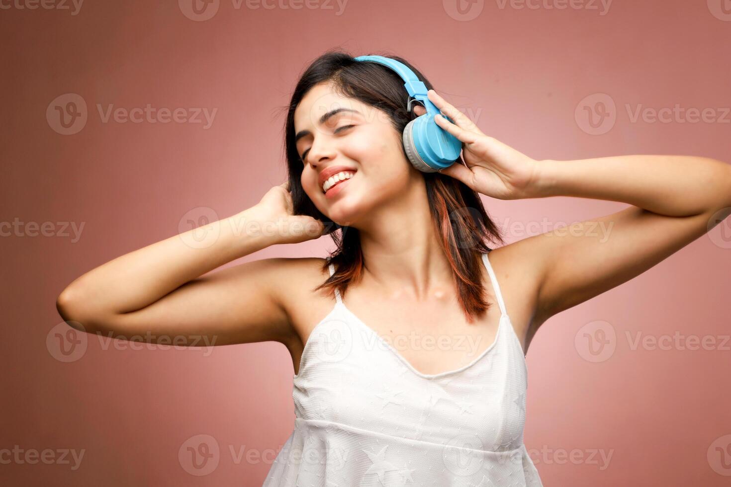 Jolly Woman With Headphone Listening Music And Having Fun photo