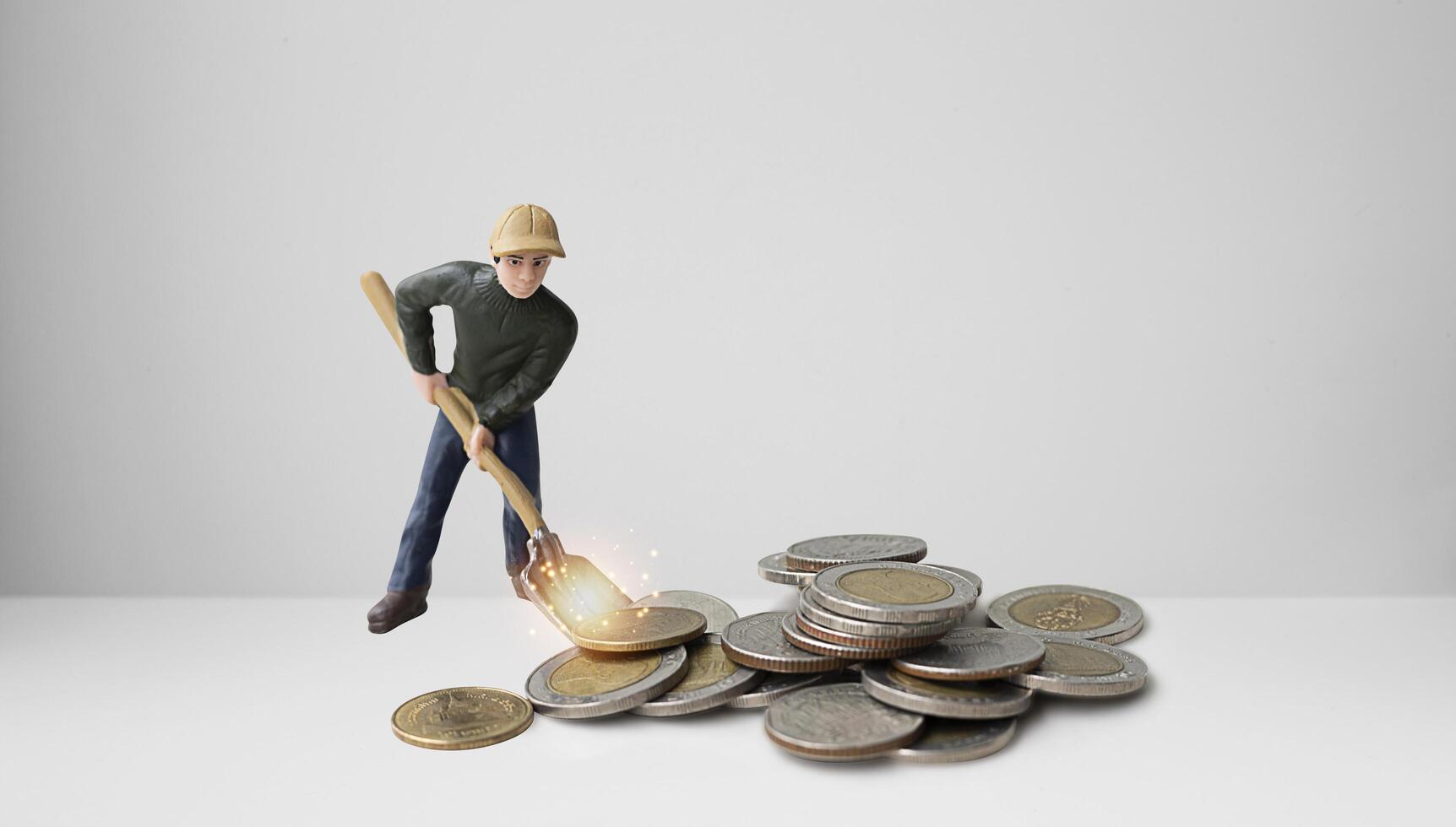 Miniature people scoop coins. Business, Money, Finance and Saving Concept. photo