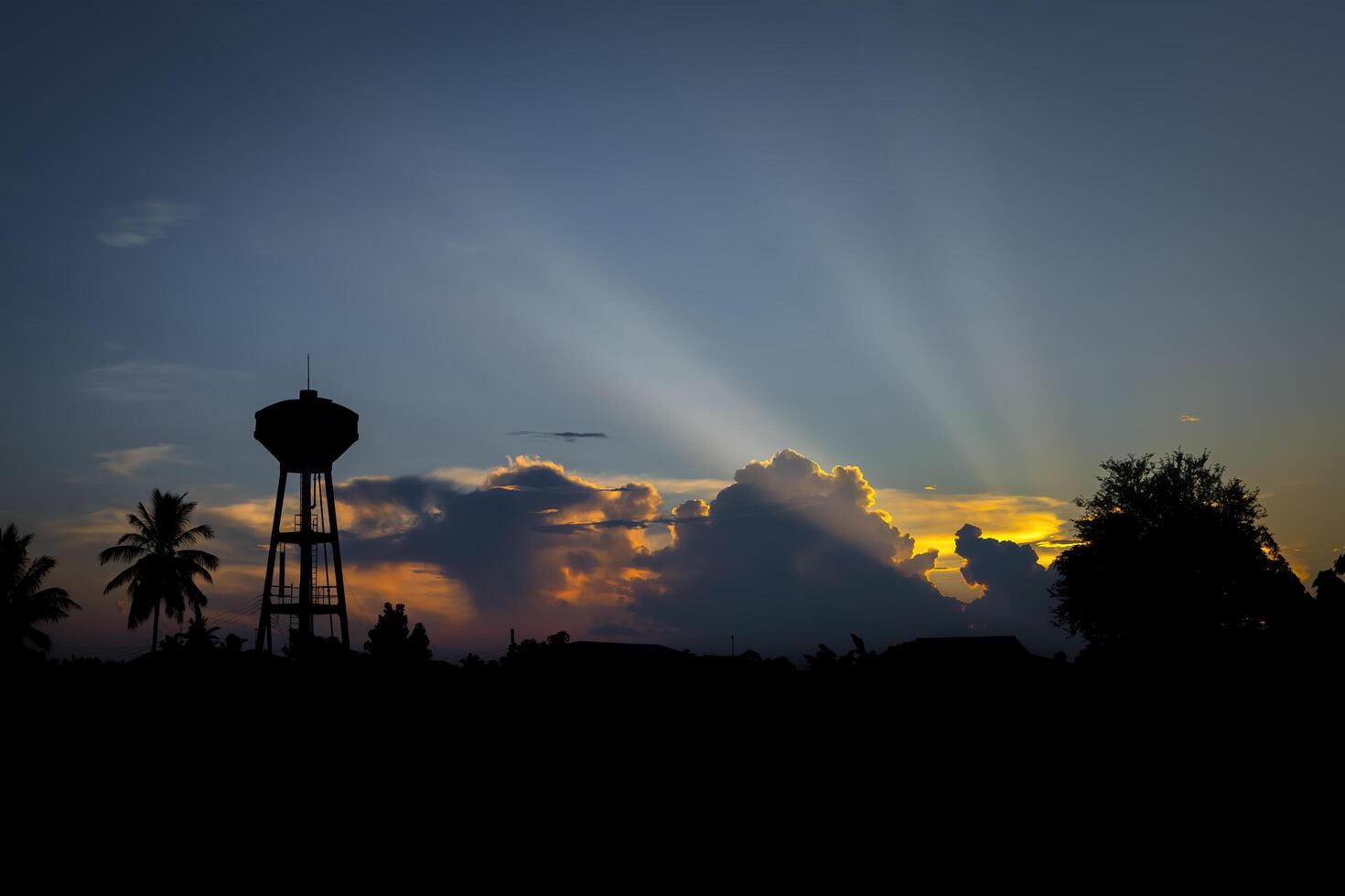 Silhouette of water tower at sunset time in the evening. photo