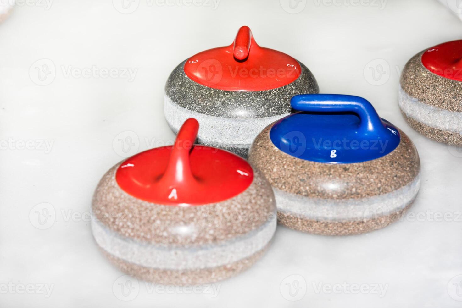 Curling stones on the ice photo