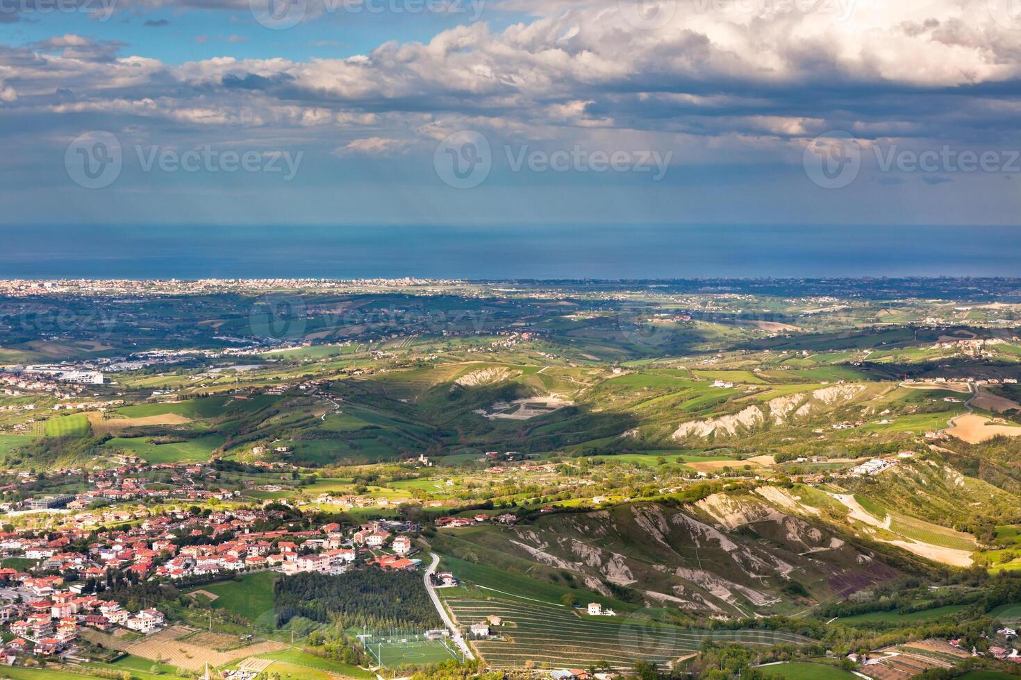 View from Titano mountain at Italian neighborhood and the sea photo