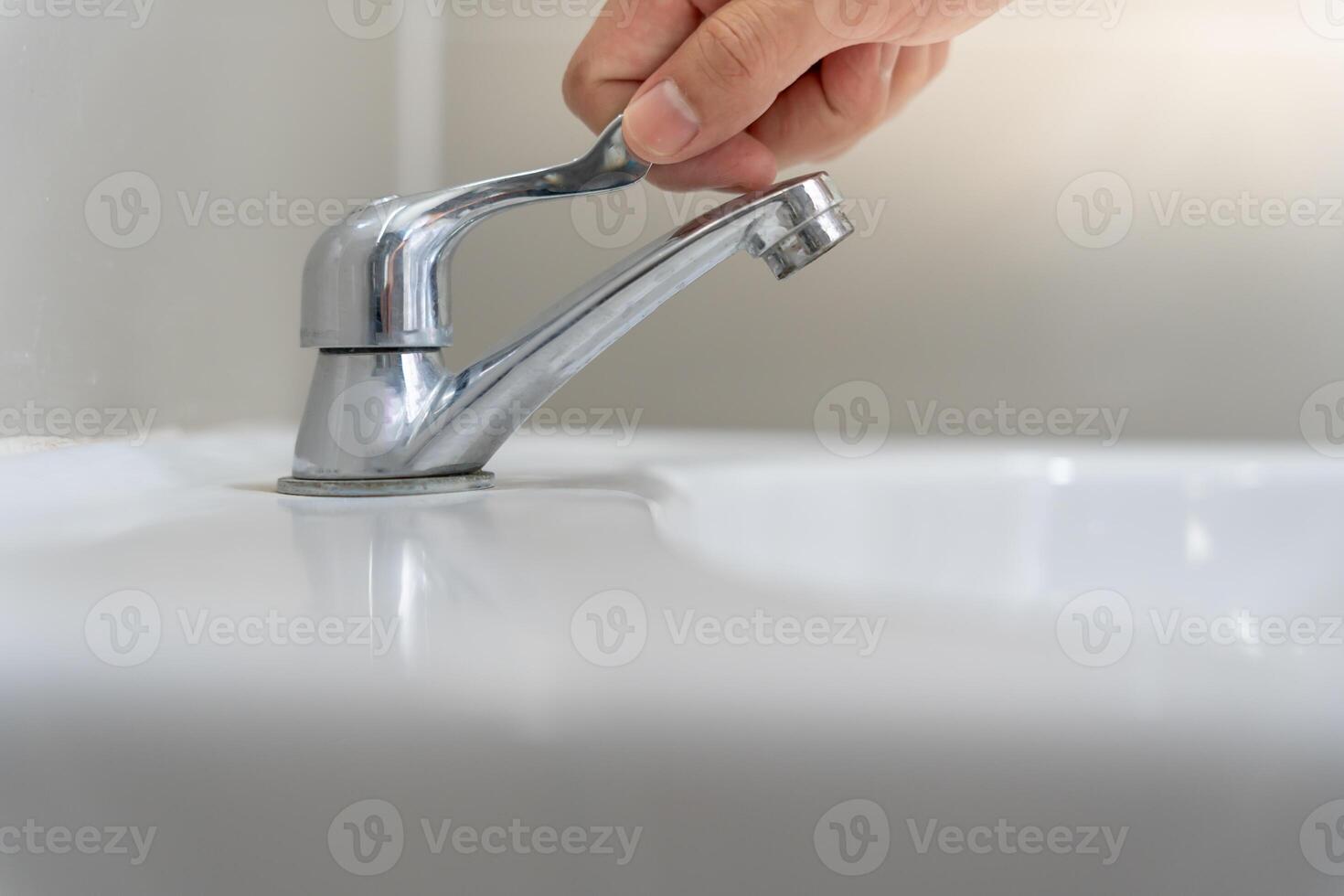 Save water. Volunteer keeps turning off the running water in the bathroom to protect environment. Greening planet, reduce global warming, Save world, life, future, risk energy, crisis , water day. photo