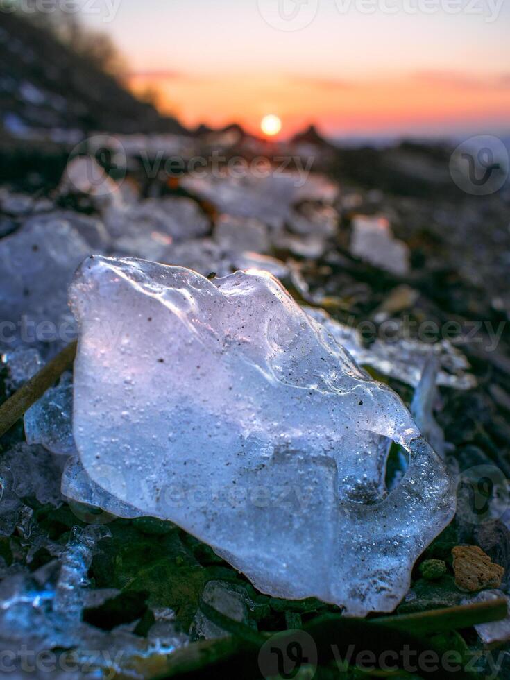 Sunset over the sea, which is covered with ice photo