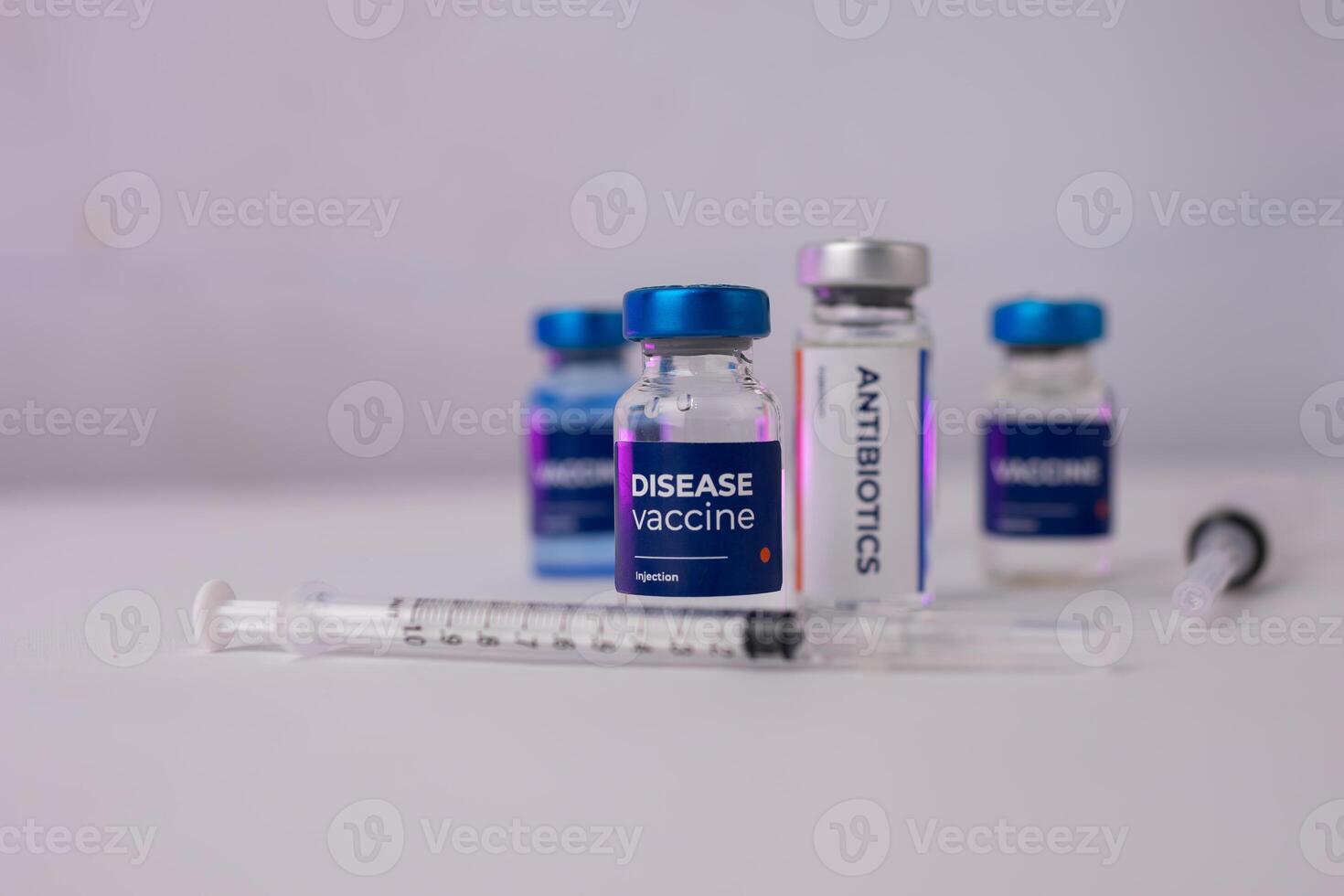 several vial tubes standing on a table and a small syringe in front of them. medical concept photo