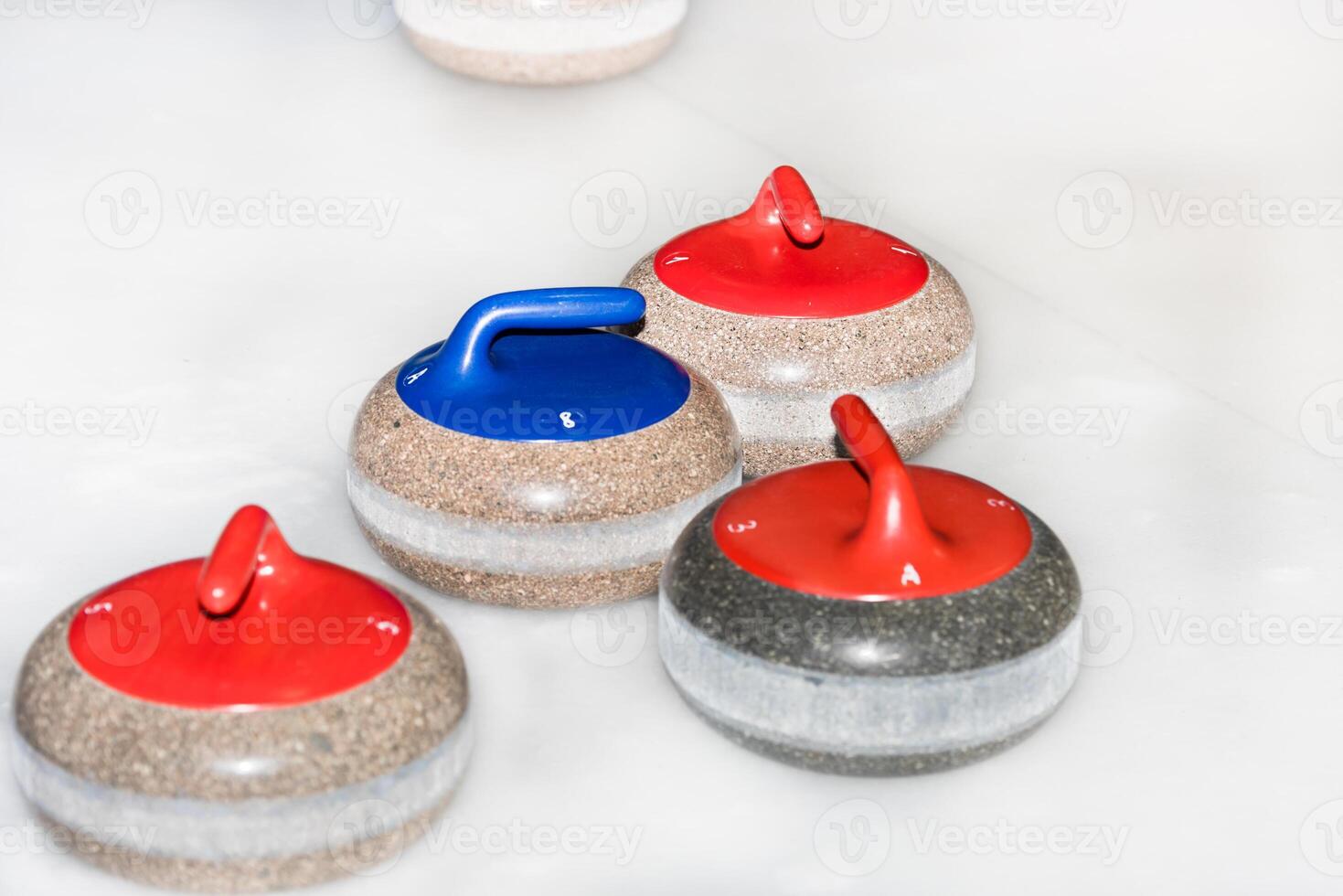 Curling stones on the ice photo