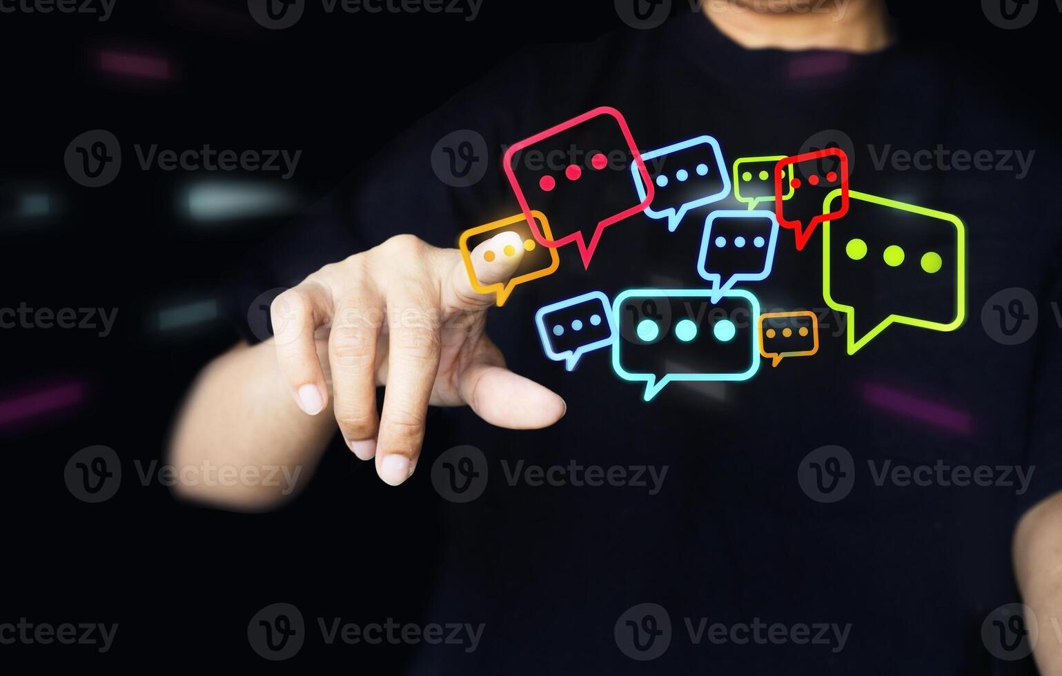 Touching with his fingers digital colorful speech bubbles talk icons. Minimal conversation or social media messages floating in front of businessman hand. photo