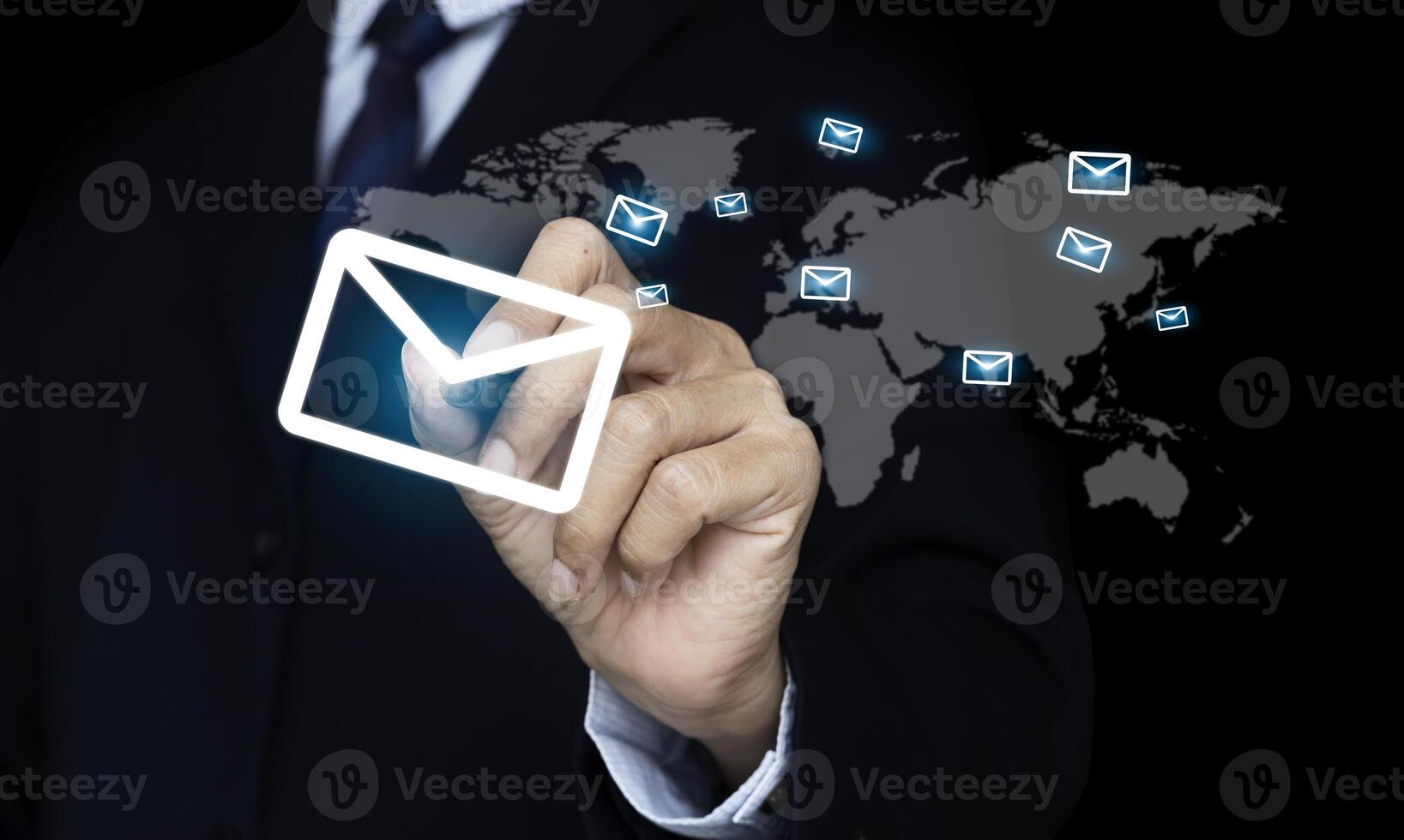 Hand pen pressing an envelope that is sent mail to the world. e-mail and marketing concept photo