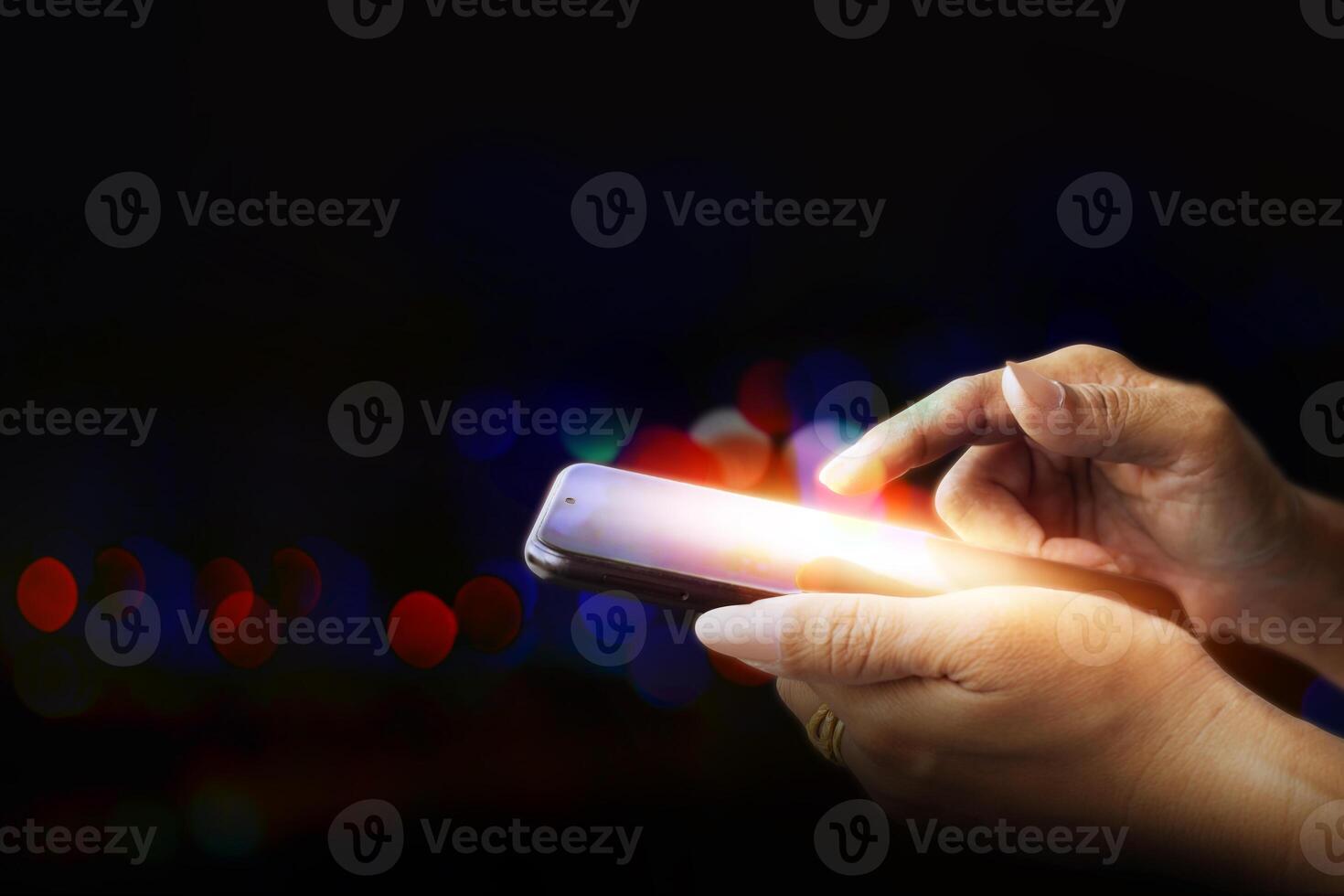 a person holding a cell phone with a light on it photo