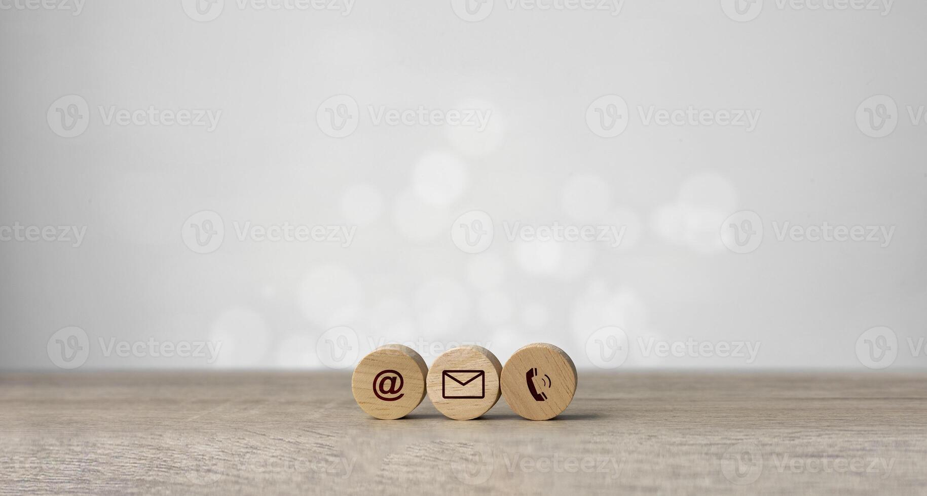 Wooden with contact icons on the table. symbol of connection, email telephone, and dialog box. Technology social network. photo