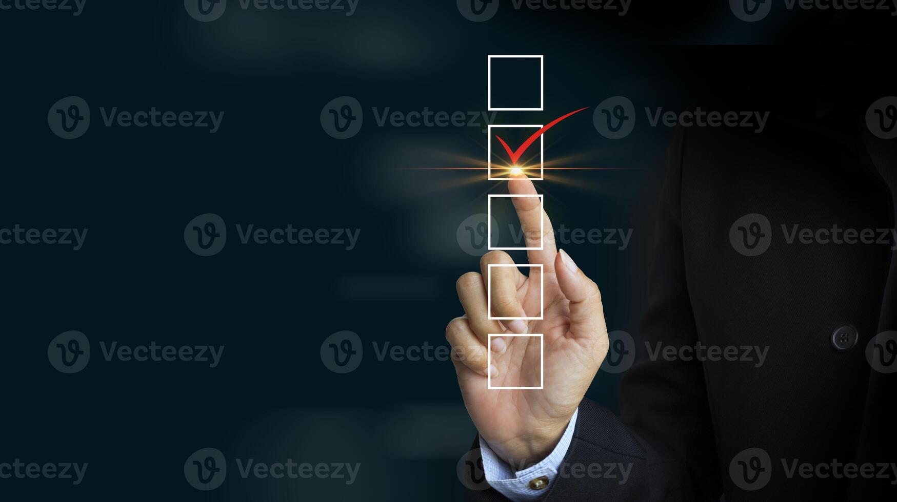 Checking mark on checklist with a red marker on dark background photo