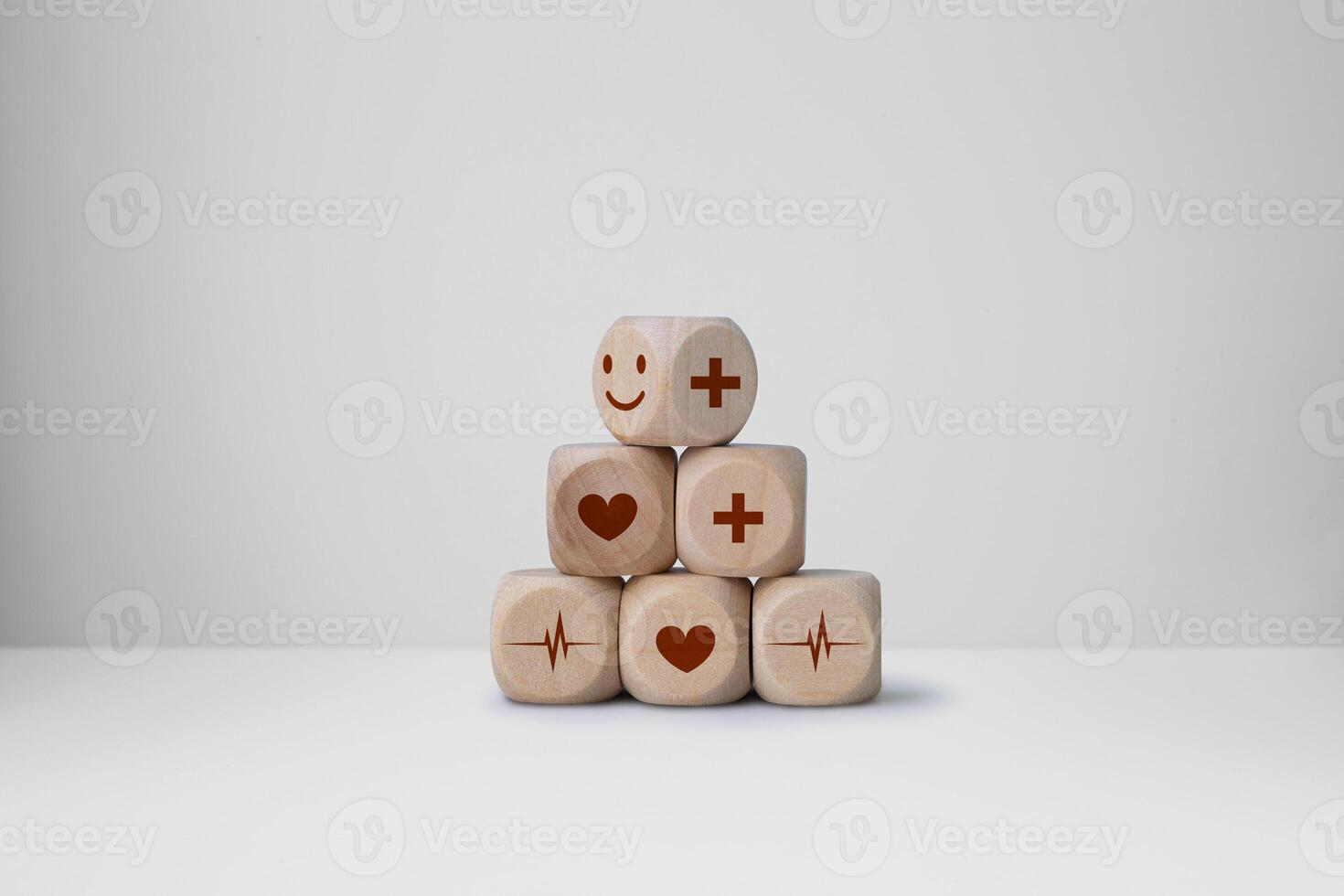 Wood cube stacking with heart health, emotion face icon. World mental health day concept photo