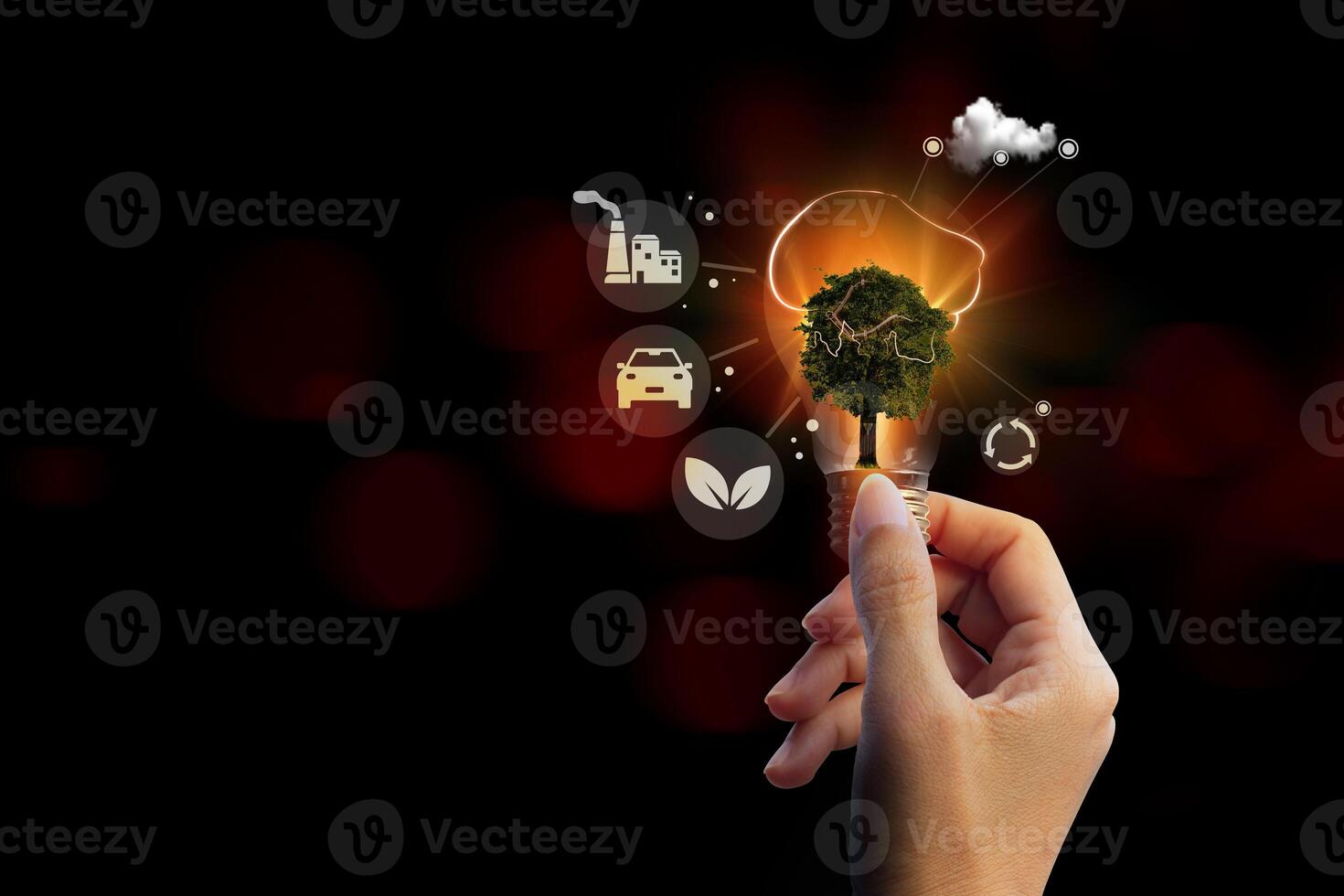 a hand holding a light bulb with a tree and icons photo