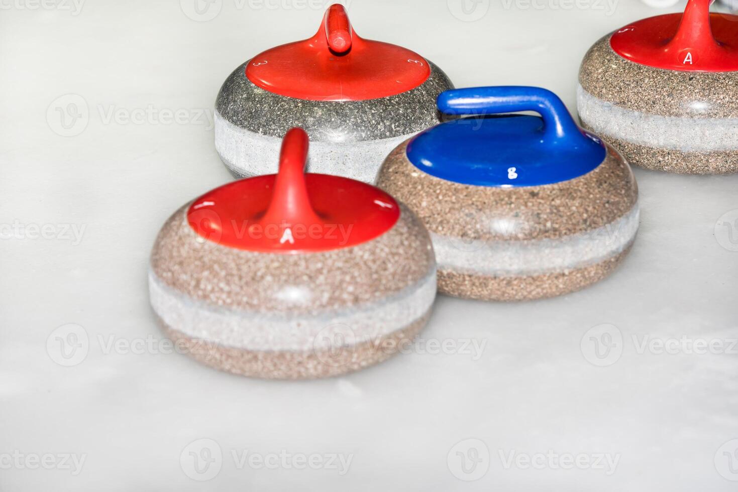 Curling stones on the ice photo