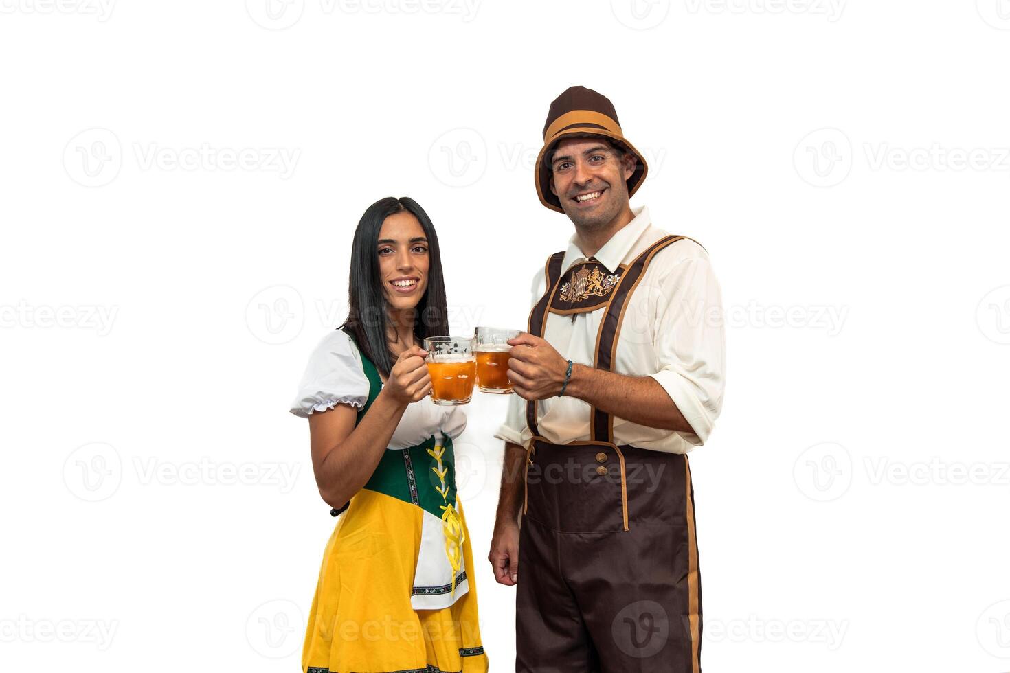 Young bavarian couple in traditional oktoberfest attire toasting with beer glasses white background photo