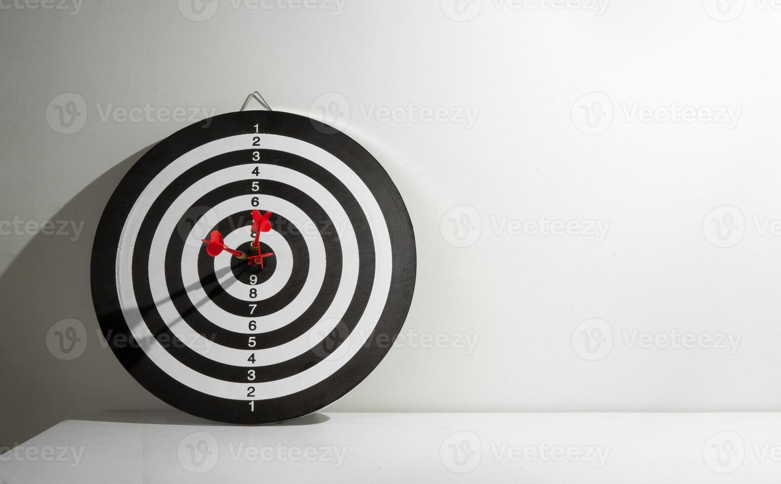 Three red arrows stuck in the target for copy space photo