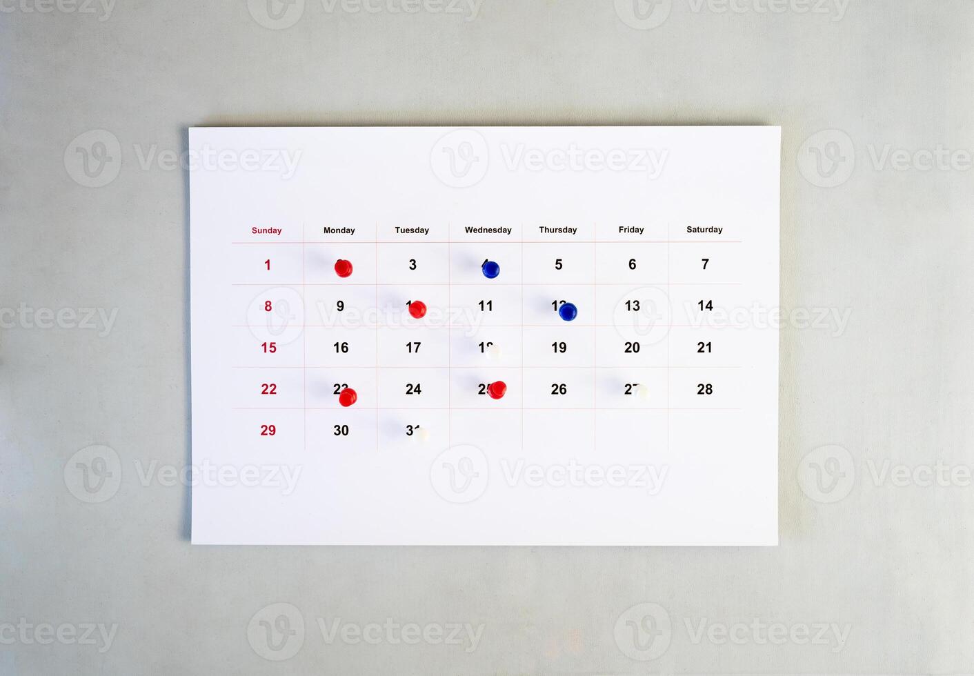 business calendar with pin stack on wall photo