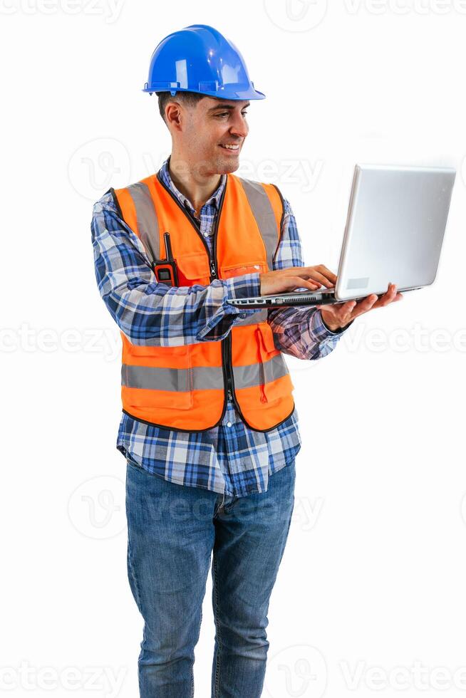vertical Construction worker sending emails with his laptop wearing orange vest and safety helmet photo
