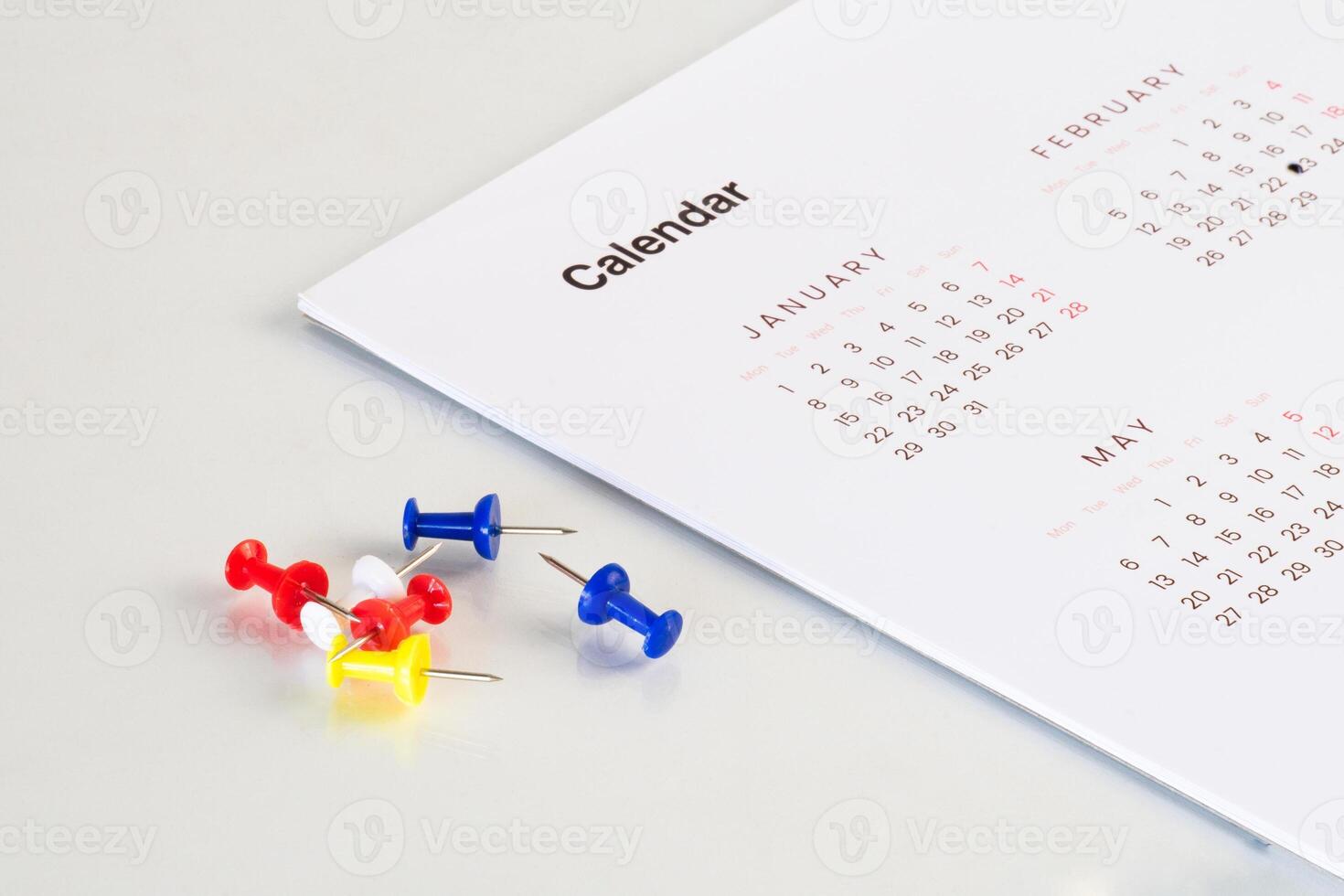 table with calendar sheet and bunch of pin photo